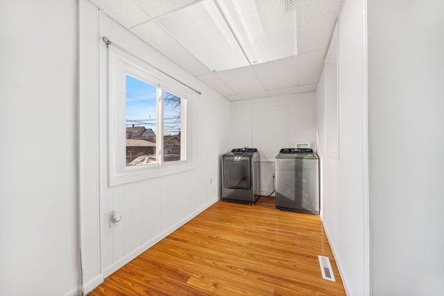 interior space with independent washer and dryer and light wood-type flooring