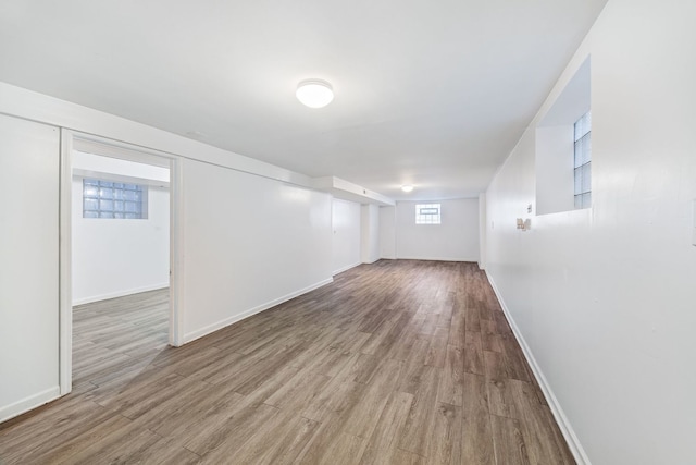 basement with light hardwood / wood-style flooring