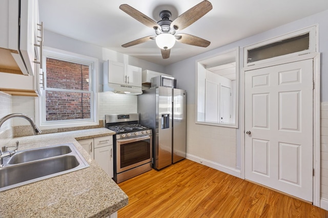 kitchen with sink, white cabinetry, tasteful backsplash, appliances with stainless steel finishes, and light hardwood / wood-style floors