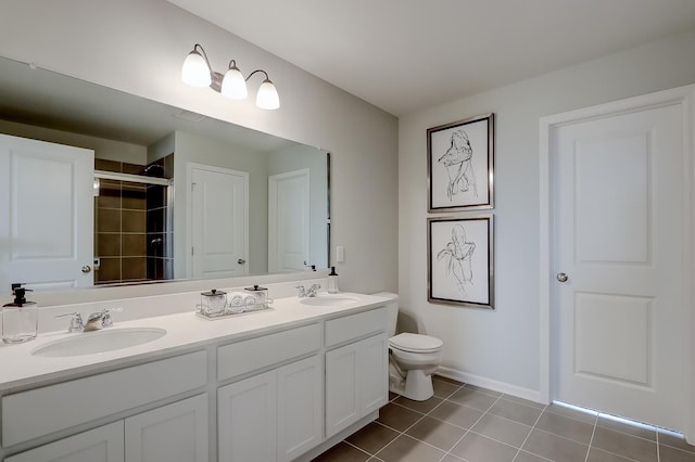 bathroom with vanity, a shower with shower door, tile patterned floors, and toilet