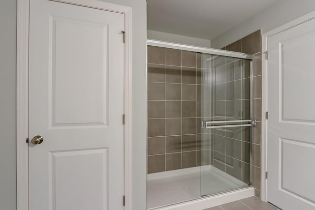 bathroom with a shower with door