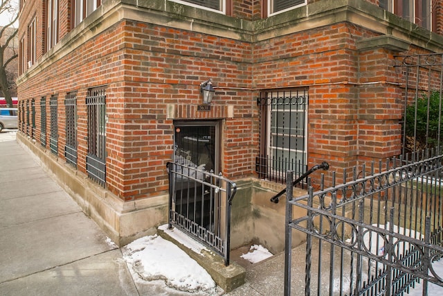 view of exterior entry with brick siding