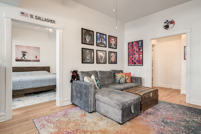 living area featuring baseboards and wood finished floors