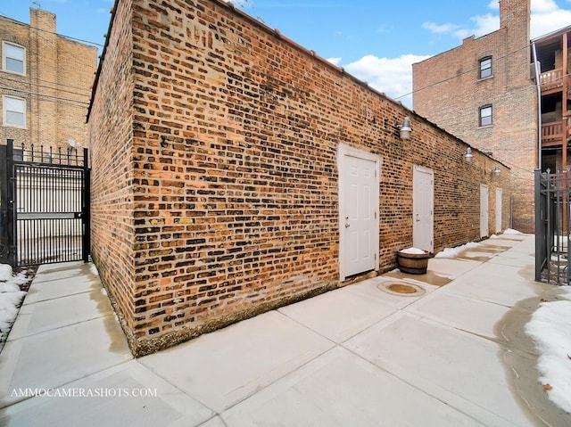 exterior space with brick siding and fence