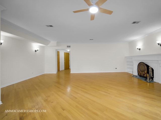 unfurnished living room featuring visible vents, baseboards, light wood-style floors, and ceiling fan