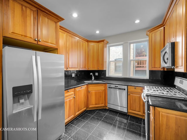 kitchen featuring a sink, recessed lighting, backsplash, and stainless steel appliances