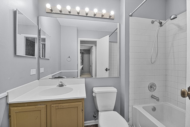 full bathroom with vanity, tiled shower / bath combo, and toilet