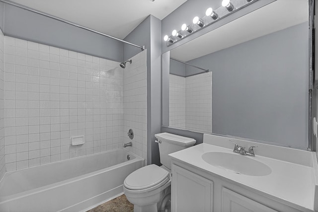 full bathroom featuring vanity, tiled shower / bath, and toilet