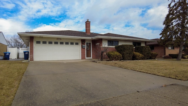 ranch-style home with a garage and a front yard