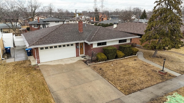 ranch-style house with a garage and a front lawn