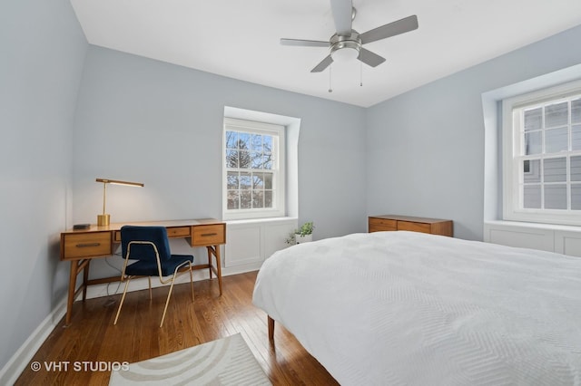 bedroom featuring baseboards, wood-type flooring, and ceiling fan