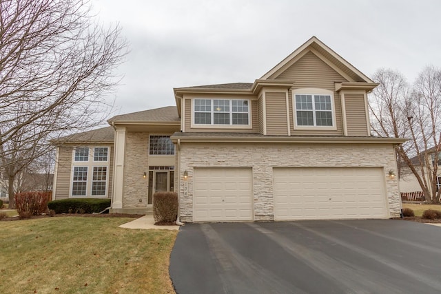 view of front property featuring a garage and a front yard