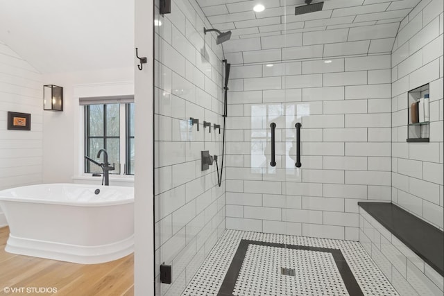 bathroom with independent shower and bath, lofted ceiling, and hardwood / wood-style floors