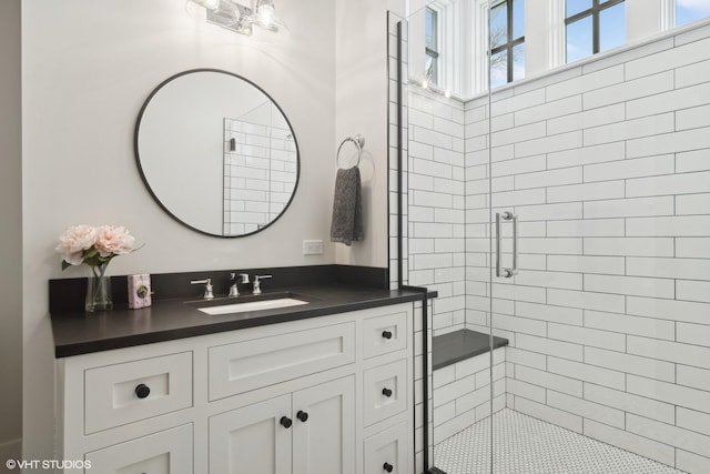 bathroom with vanity and a shower with shower door