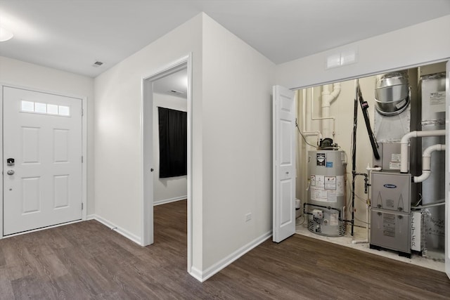 entrance foyer featuring heating unit, dark hardwood / wood-style flooring, and water heater