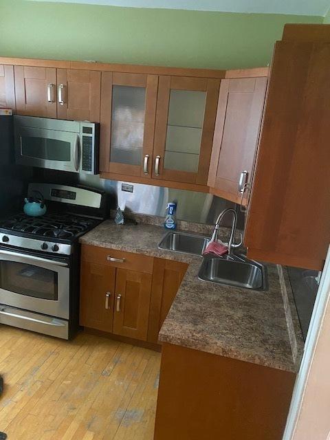 kitchen featuring sink, stainless steel appliances, and light wood-type flooring