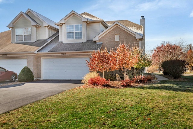 view of front facade with a garage and a front lawn