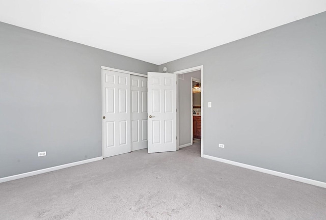 unfurnished bedroom with a closet and carpet