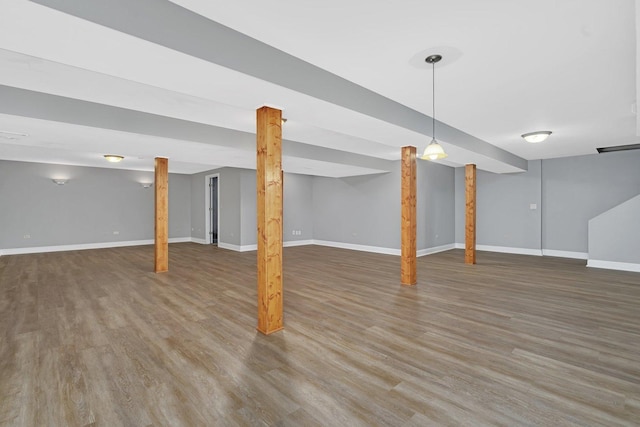 basement with dark hardwood / wood-style flooring