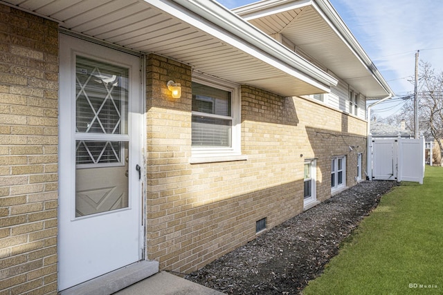 doorway to property with a lawn