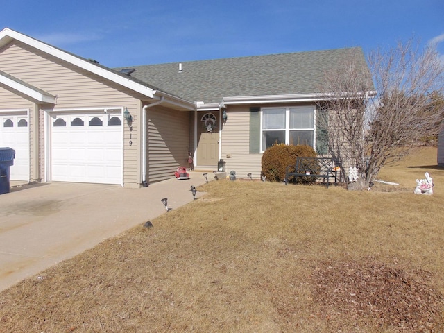 ranch-style home with a garage and a front yard