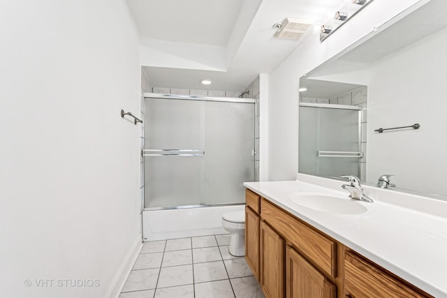 bathroom featuring vanity, baseboards, visible vents, bath / shower combo with glass door, and toilet