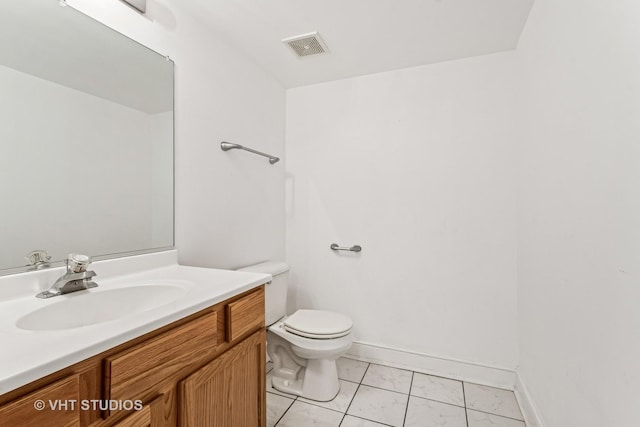 bathroom with vanity, baseboards, visible vents, tile patterned flooring, and toilet