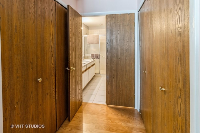 hall featuring light tile patterned floors