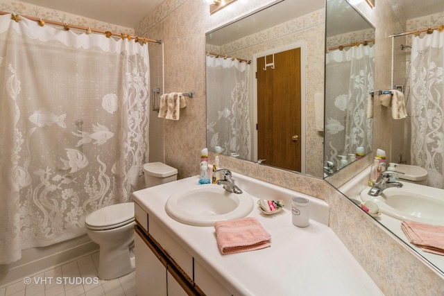 full bathroom with tile patterned flooring, vanity, toilet, and shower / bath combo with shower curtain