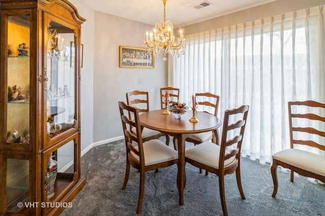 carpeted dining space with a chandelier