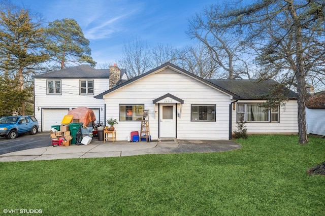 view of front facade with a garage, a patio area, and a front lawn