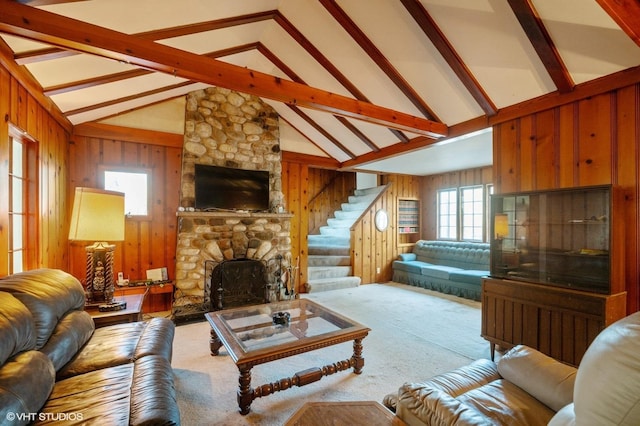 carpeted living room featuring beamed ceiling, a stone fireplace, high vaulted ceiling, and wood walls