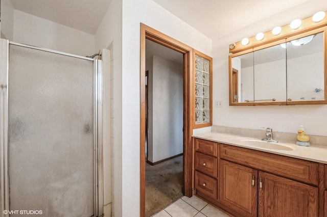 bathroom with walk in shower, tile patterned floors, and vanity