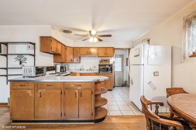 kitchen featuring range with electric stovetop, kitchen peninsula, white refrigerator, ceiling fan, and light hardwood / wood-style floors