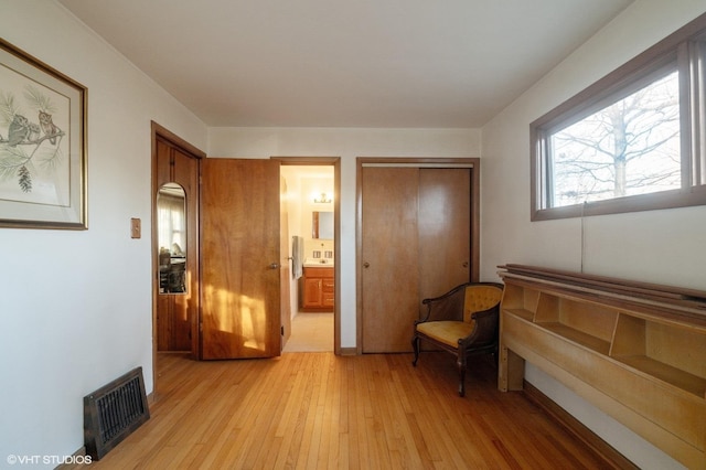 sitting room featuring light hardwood / wood-style flooring