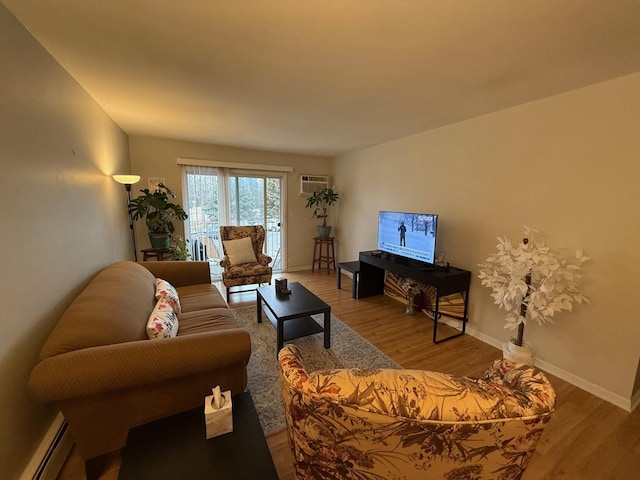 living room with a wall mounted AC, hardwood / wood-style floors, and baseboard heating