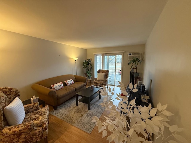 living room featuring light hardwood / wood-style flooring and a wall mounted AC