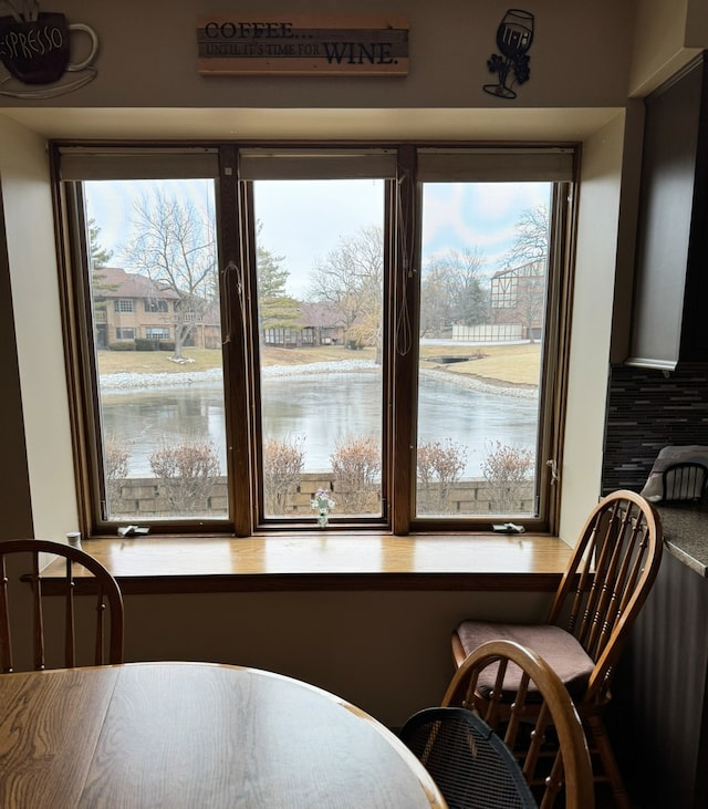 dining space featuring a water view