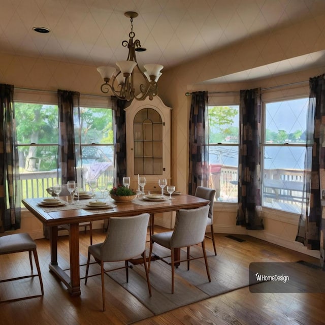 dining space with an inviting chandelier and hardwood / wood-style floors