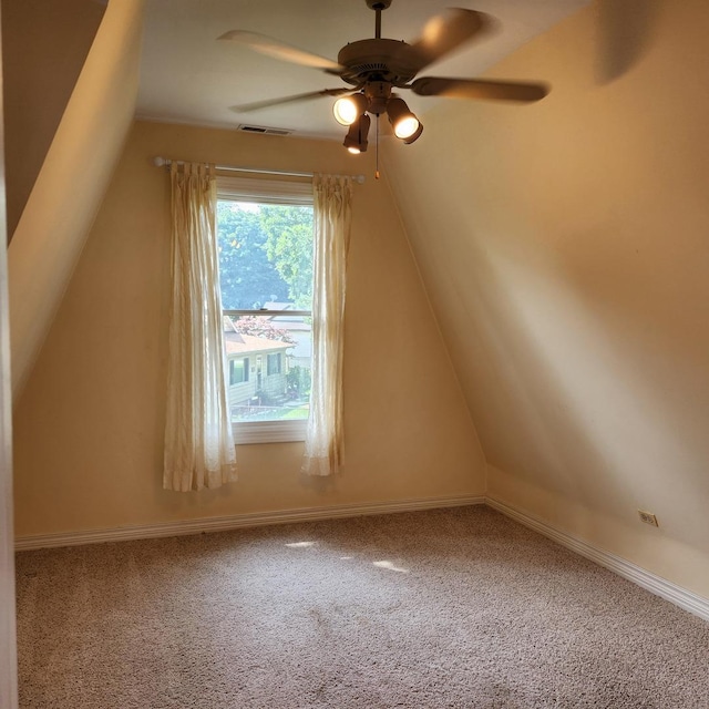 bonus room featuring lofted ceiling, carpet flooring, and ceiling fan