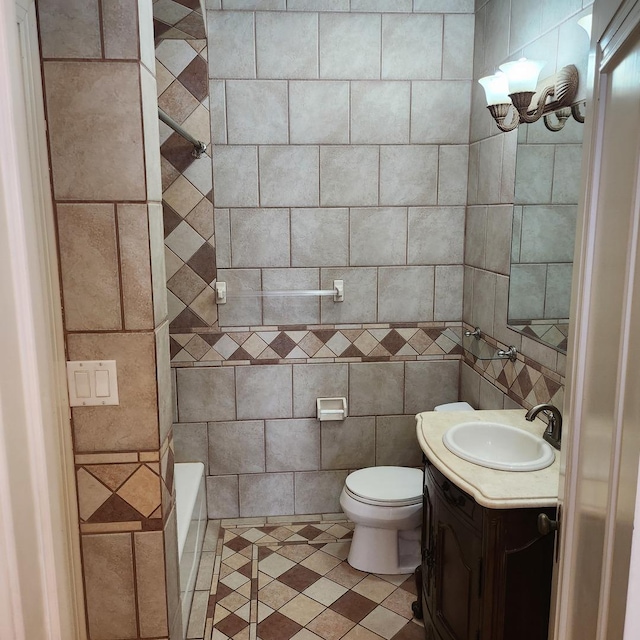 bathroom with vanity, a bathing tub, and toilet