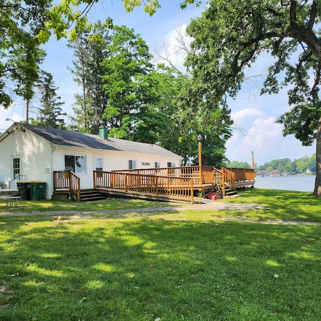 view of yard featuring a deck with water view