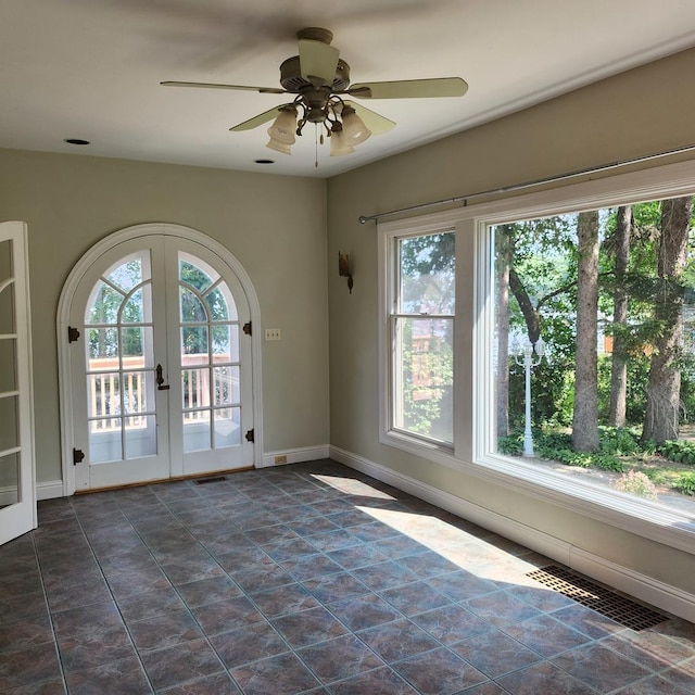 empty room with french doors and ceiling fan