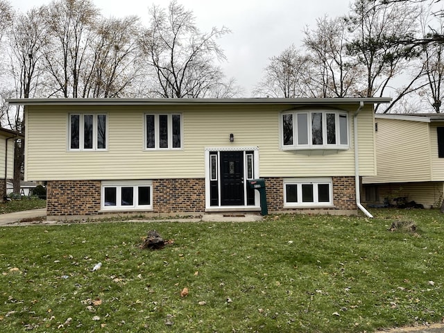 back of house with a lawn