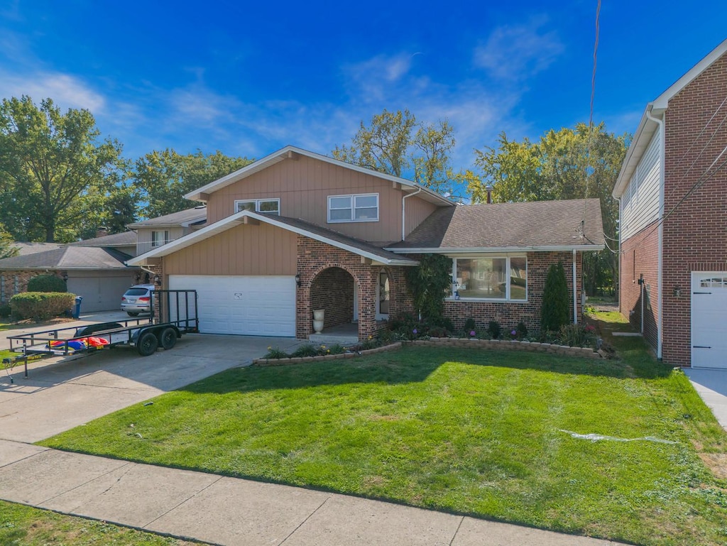 view of front of house with a garage and a front lawn