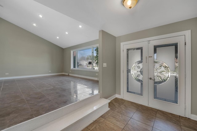 entrance foyer featuring lofted ceiling and french doors