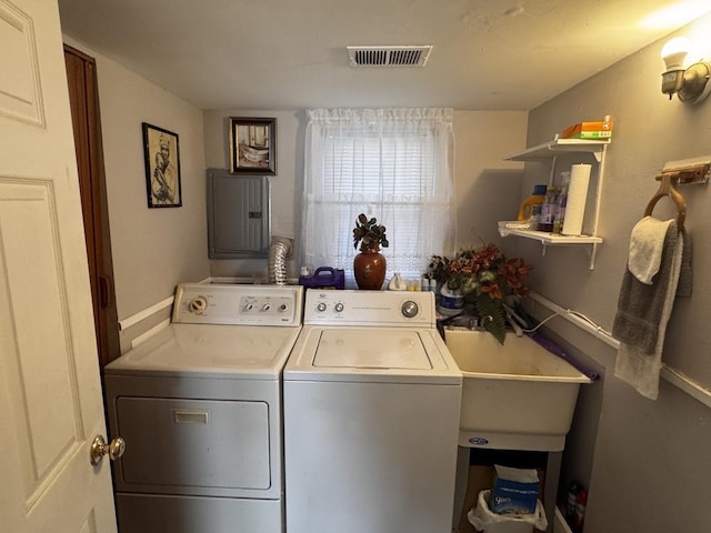 washroom with separate washer and dryer, sink, and electric panel