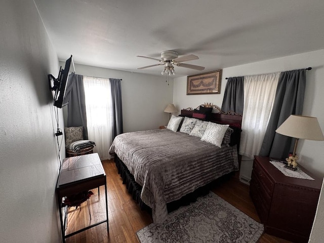 bedroom with dark wood-type flooring and ceiling fan