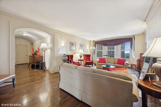 living room featuring dark wood-type flooring and crown molding