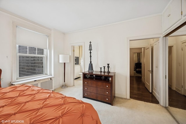 bedroom featuring crown molding, radiator, and light colored carpet